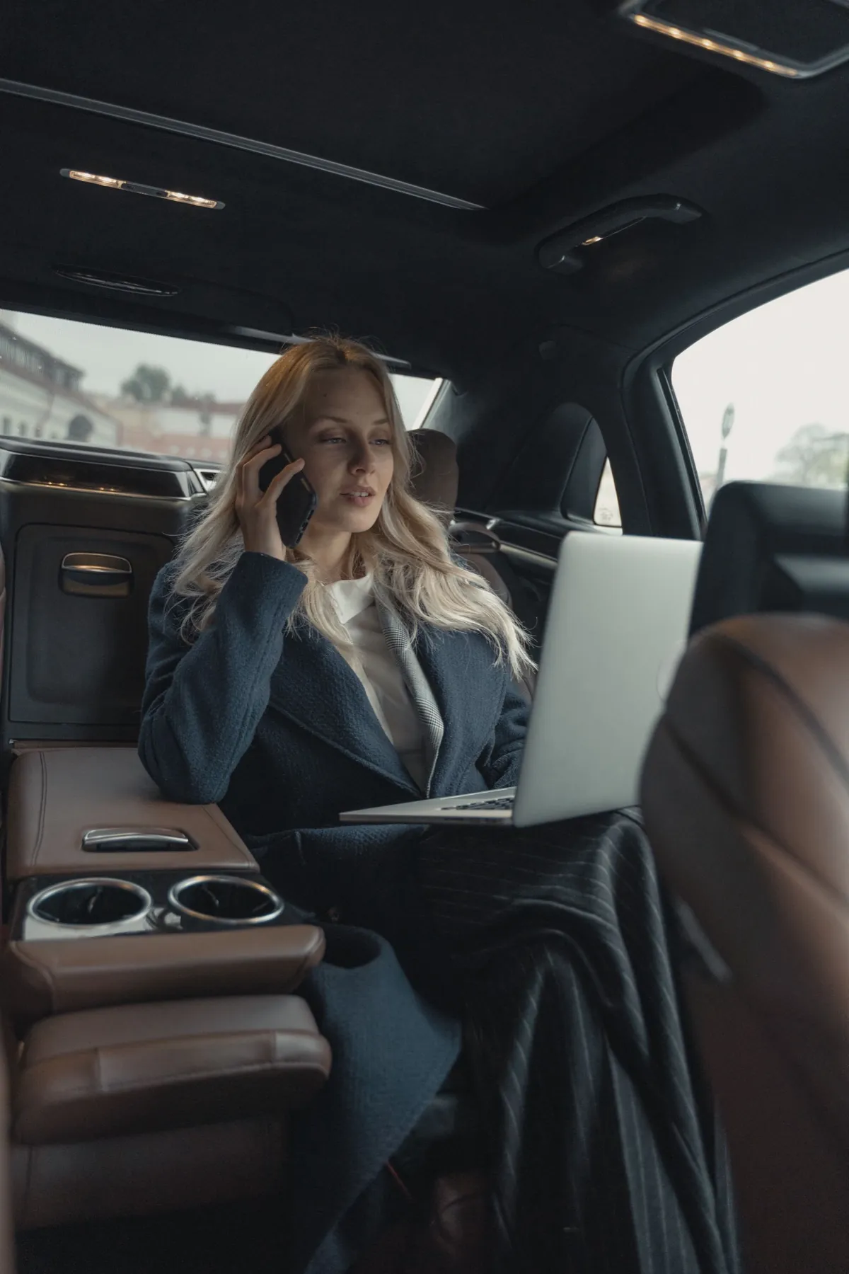 Business traveler working in the back seat