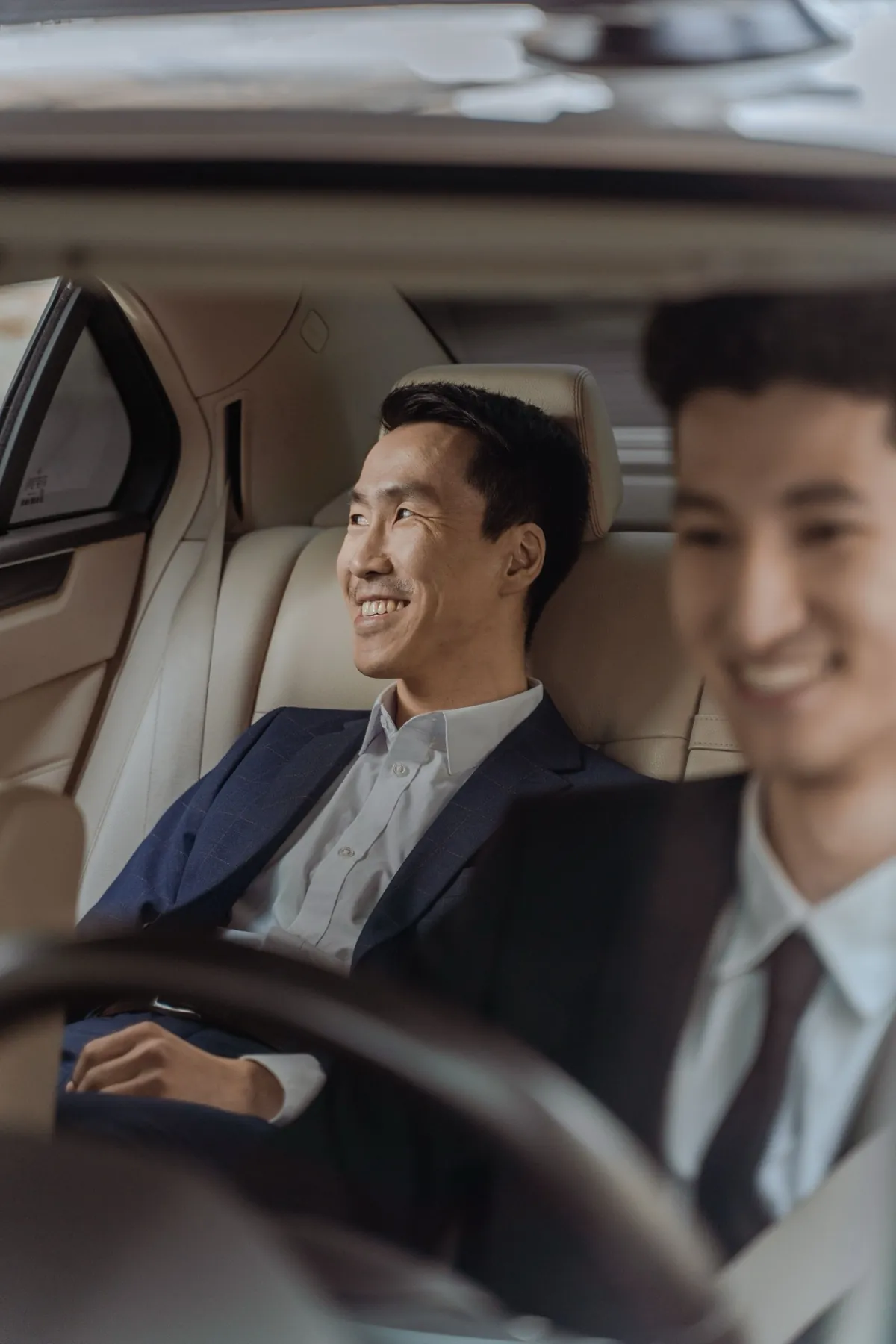Passenger relaxing in the back seat of a car