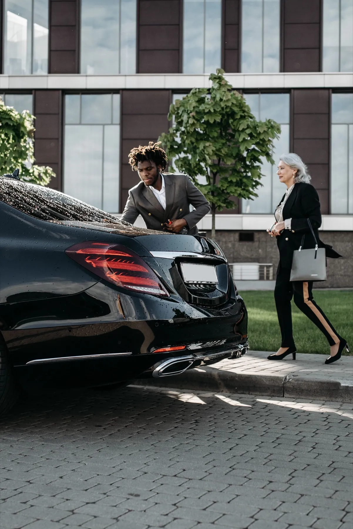 Chauffeur walking a passenger to a car